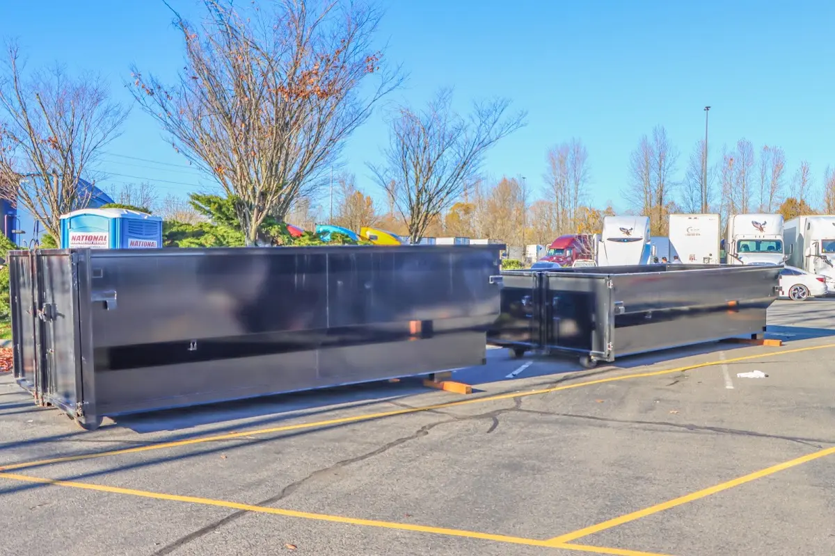 Professional dumpster rental service with roll-off container on residential driveway in Moores Mill